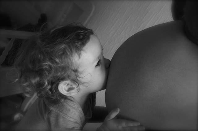 baby kissing pregnant belly